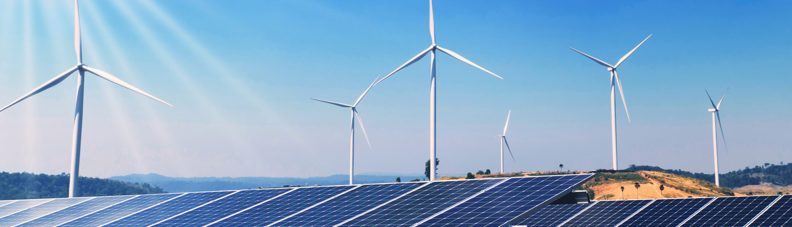 concept clean energy power in nature. solar panels and wind turbine on hill